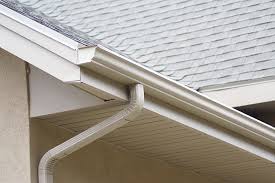 A plastic gutter installed on the edge of a roof