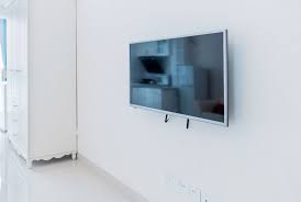  A TV screen hanging on a white interior wall 