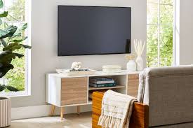 A TV screen mounted on the wall in the living room