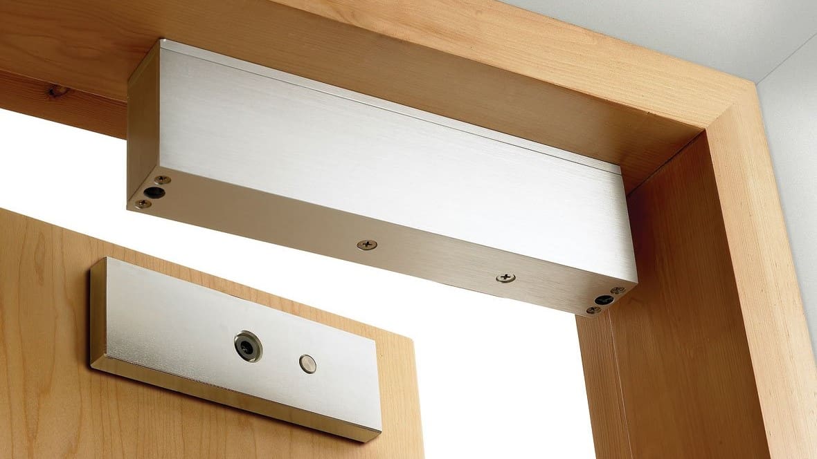 A magnetic lock on a wooden door