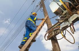 A hand fixing an electrical panel