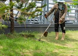 A man operating a grass-cutting machine