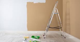 A partially painted wall and a ladder