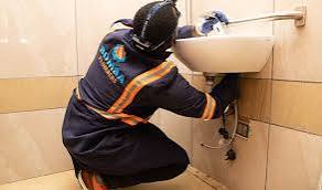 A plumber fixing a sink