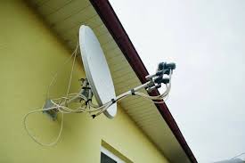 A Satellite dish installed on the top side of a building