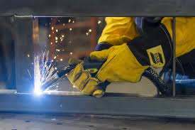 A hand with gloves welding metals