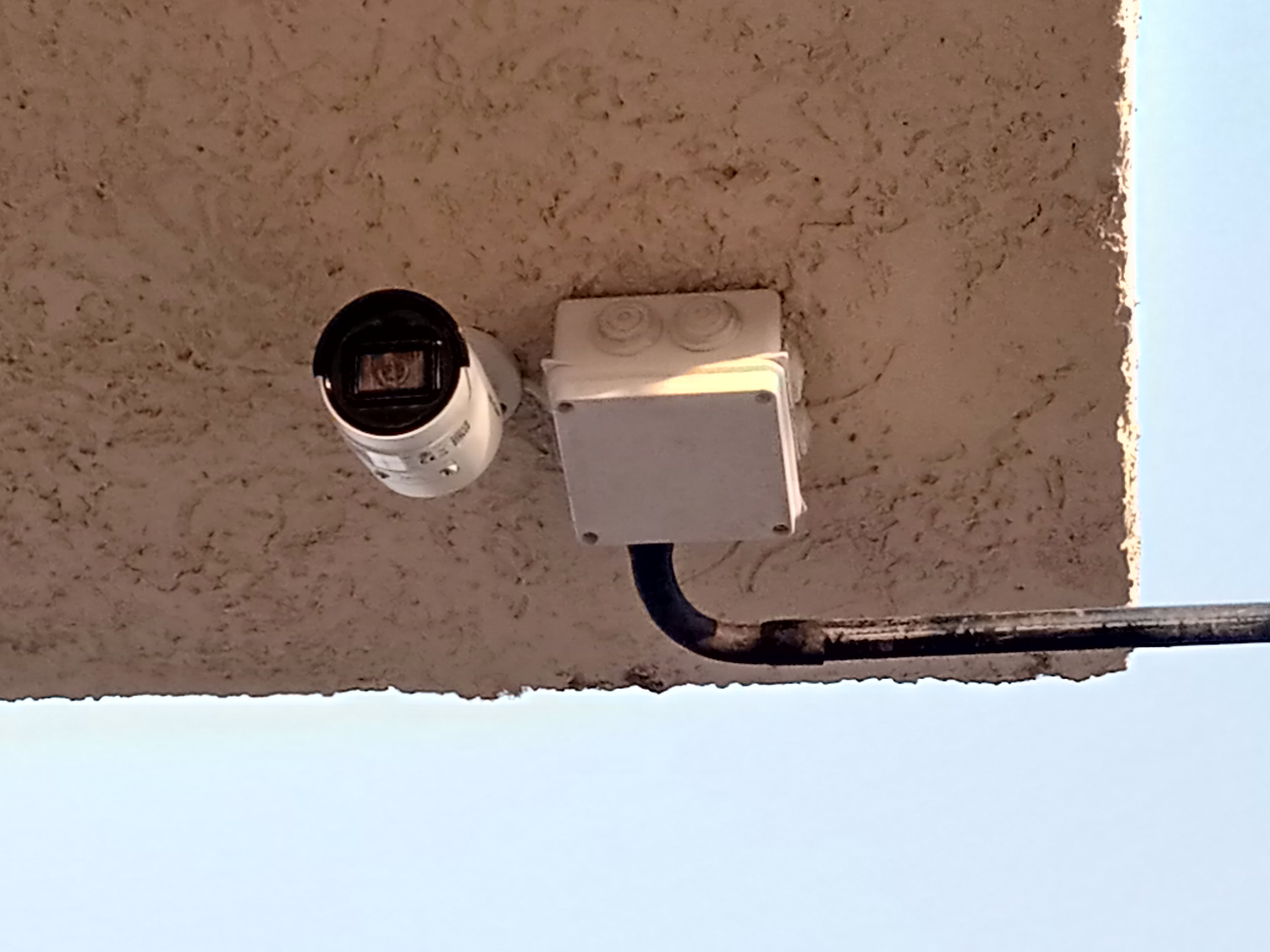 A hikvision bullet camera on the outside ceiling watching the entrances of a supermarket in Juba, South Sudan